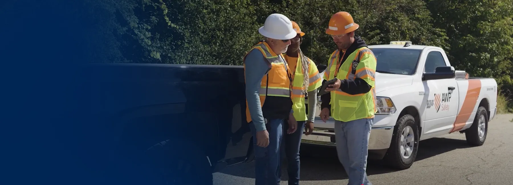 Three employees going over safety procedures in the field.