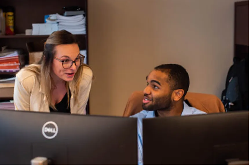 Two employees working collaboratives in an office.