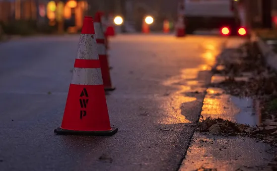 A road flanked by orange AWP traffic cones.