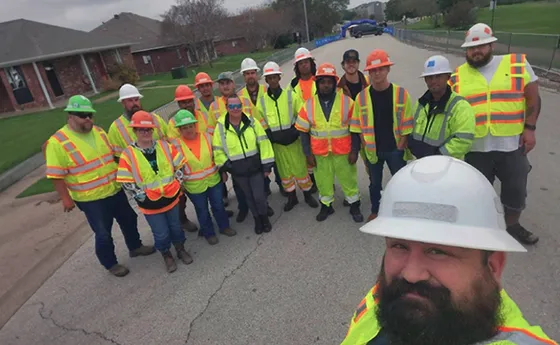 A group of protectors posing for a photo at a jobsite.