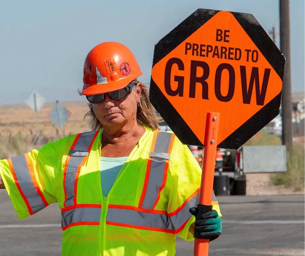 An AWP Protector with a sign that says “Be Prepared to Grow.”