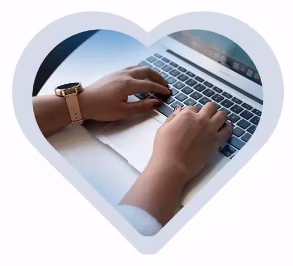 A person typing on a laptop keyboard