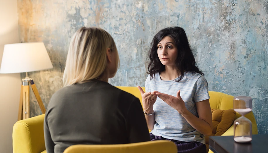 A psychiatrist talking with a patient in a calm office setting