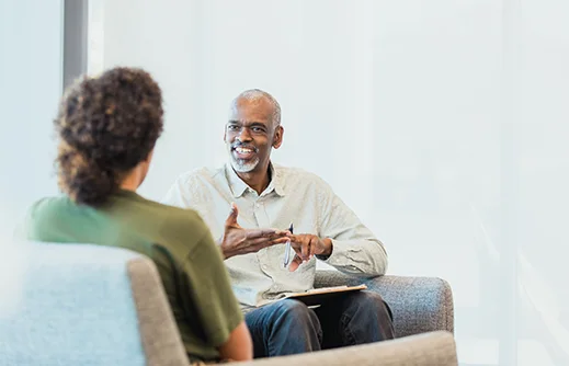 A psychiatrist talking with a patient in a calm office setting