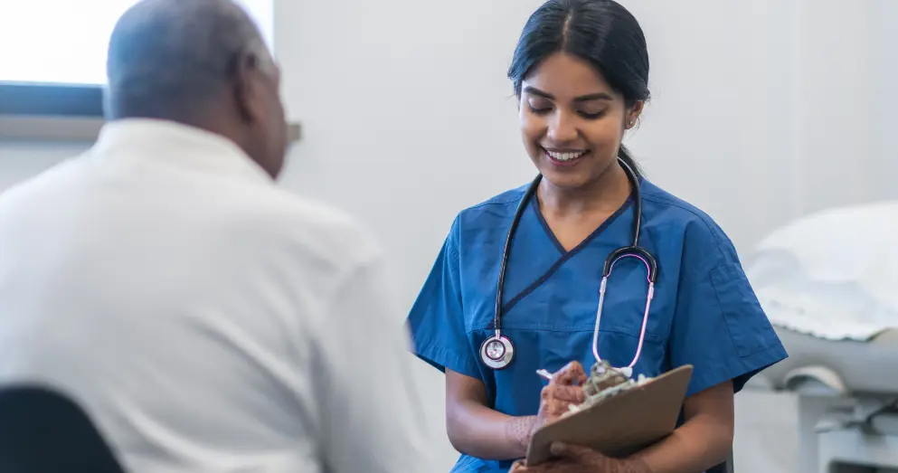  	A nurse with a clipboard speaking to a patient.