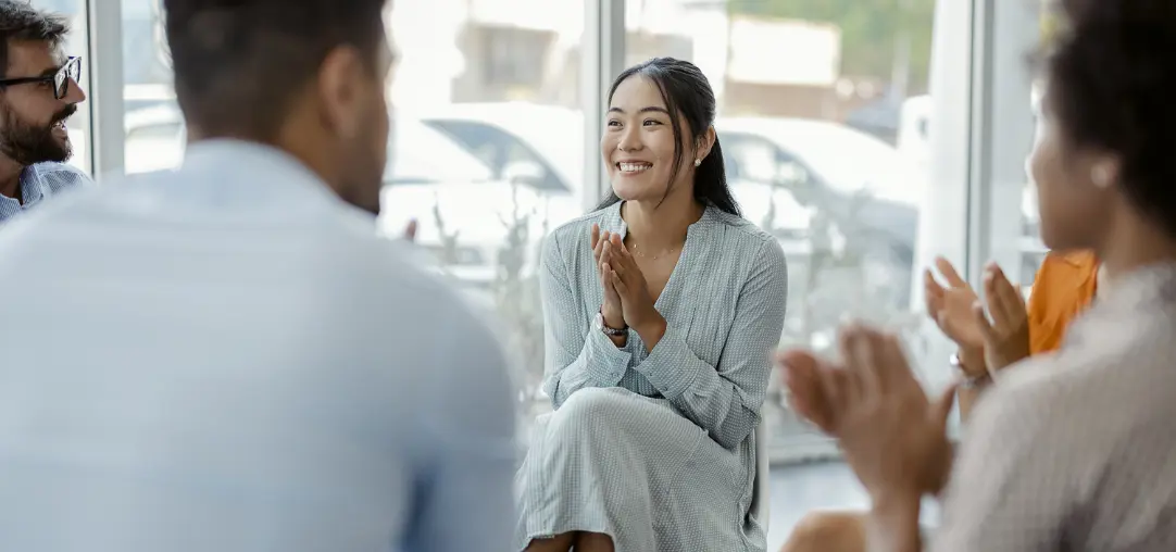  	Healthcare employee leading a group meeting.