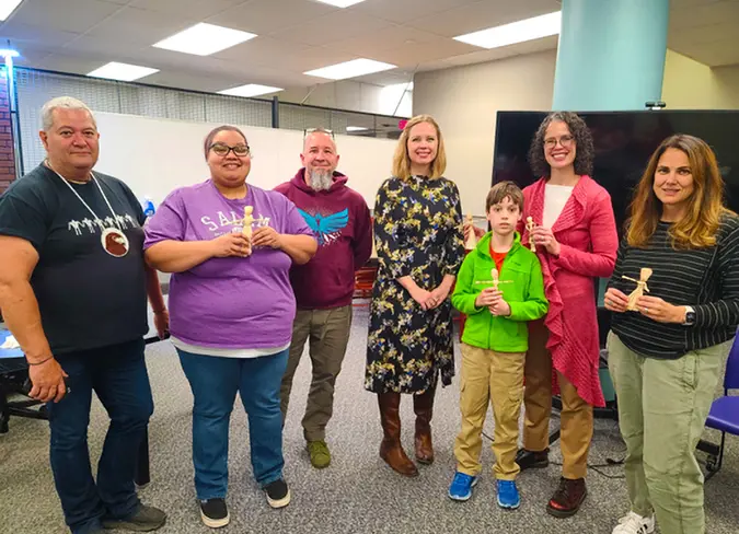 Group phot of CareSource employees and a kid in green jacket