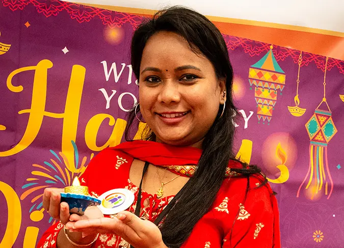 CareSource employee holding a candle during holiday event