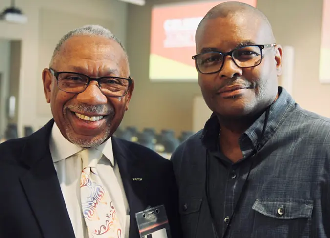 Two male employees at the CareSource conference meeting