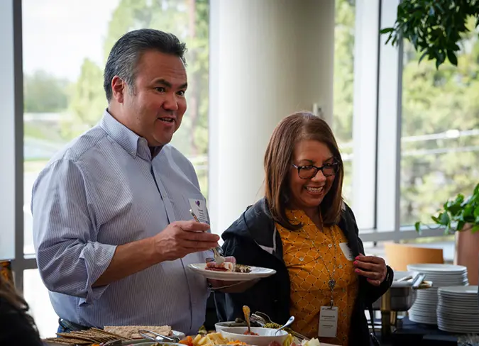 Two CareSource employees toasting during the banquet