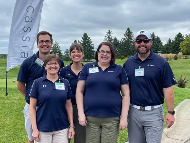 Cassia team members smiling at a golf tournament