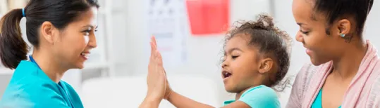 kid giving five to a nurse