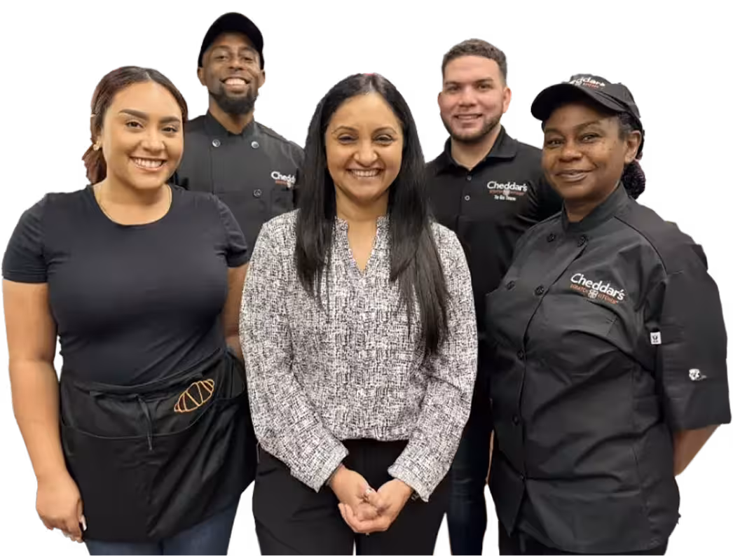 A group of Cheddar’s employees smiling.