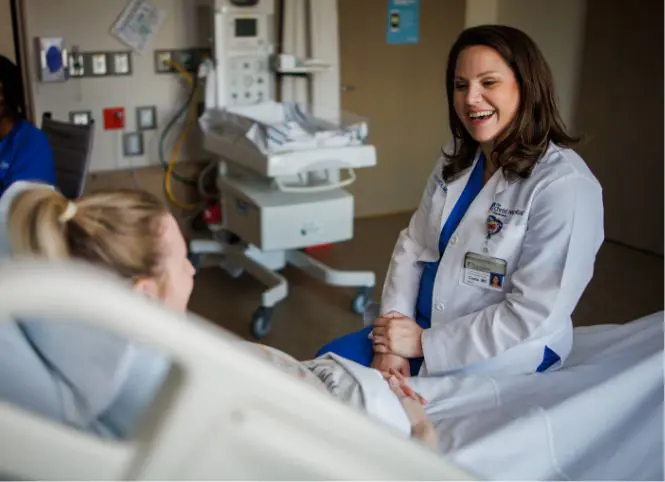 A Christ Hospital doctor smiling at a patient with text that reads &ldquo;95th percentile or above for patient experience (Press Ganey)&rdquo;