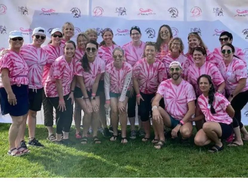 A group of Christ Hospital employees smiling at a community event