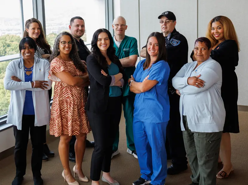 A group of Christ Hospital employees posting with a banner that reads “# For the pursuit of diversity and inclusion”