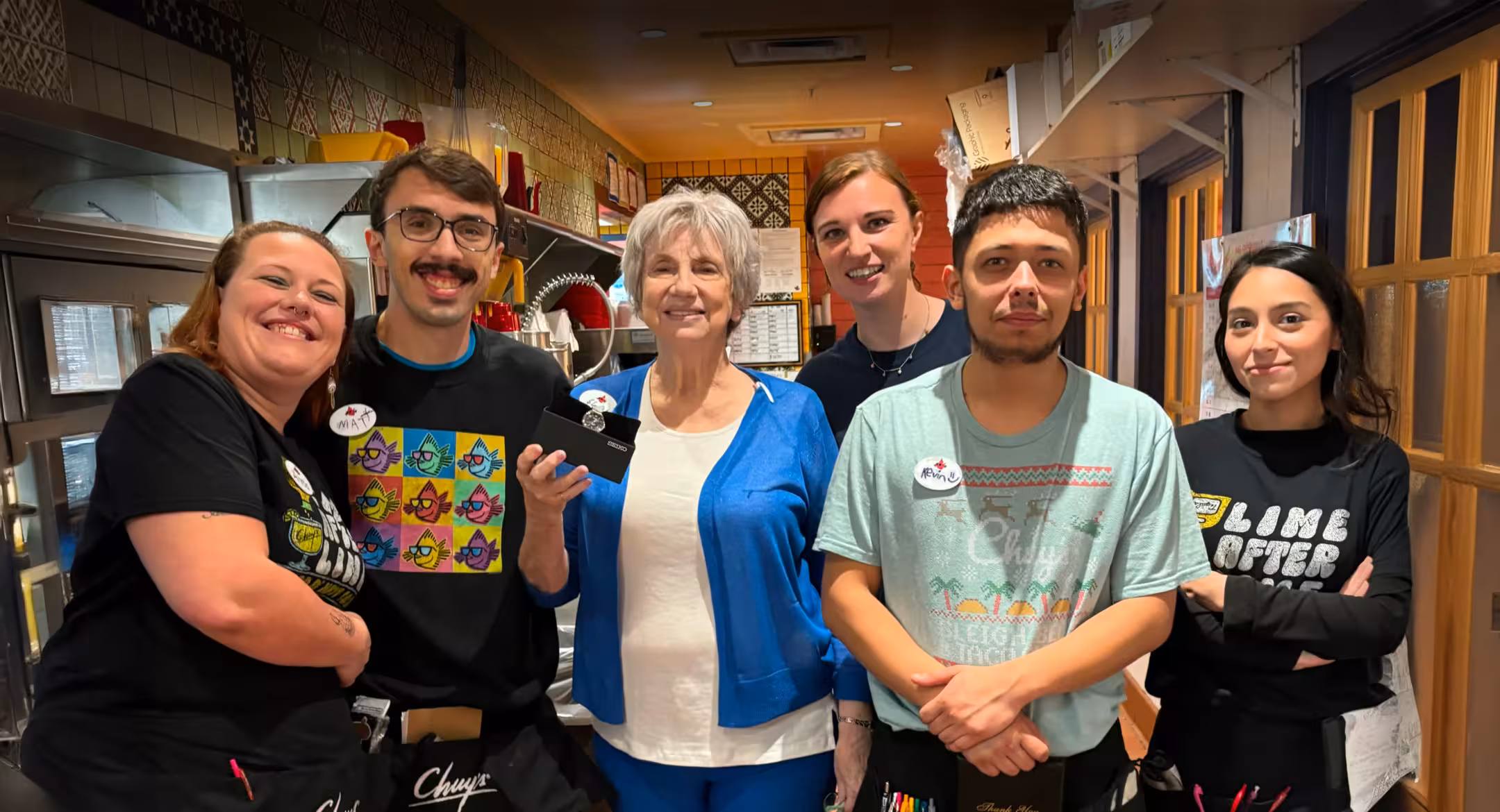 A Chuy’s manager smiling and talking with a team member.