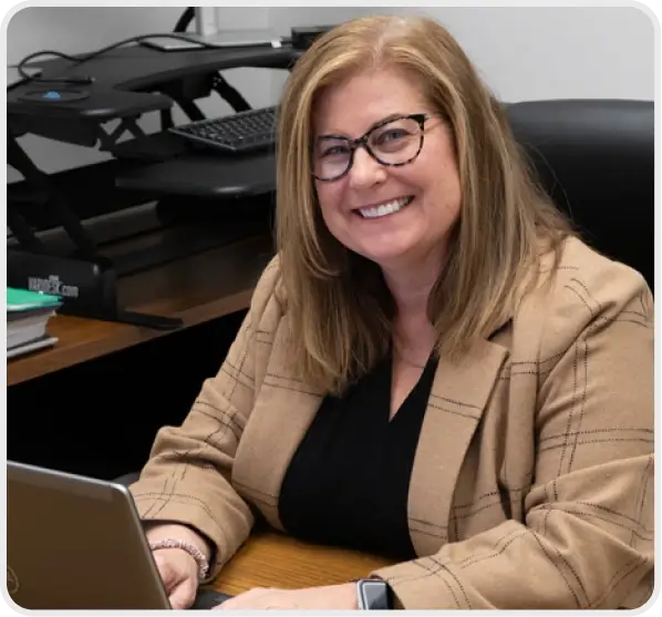 A Cincinnati Incorporated employee sitting and typing on a laptop.