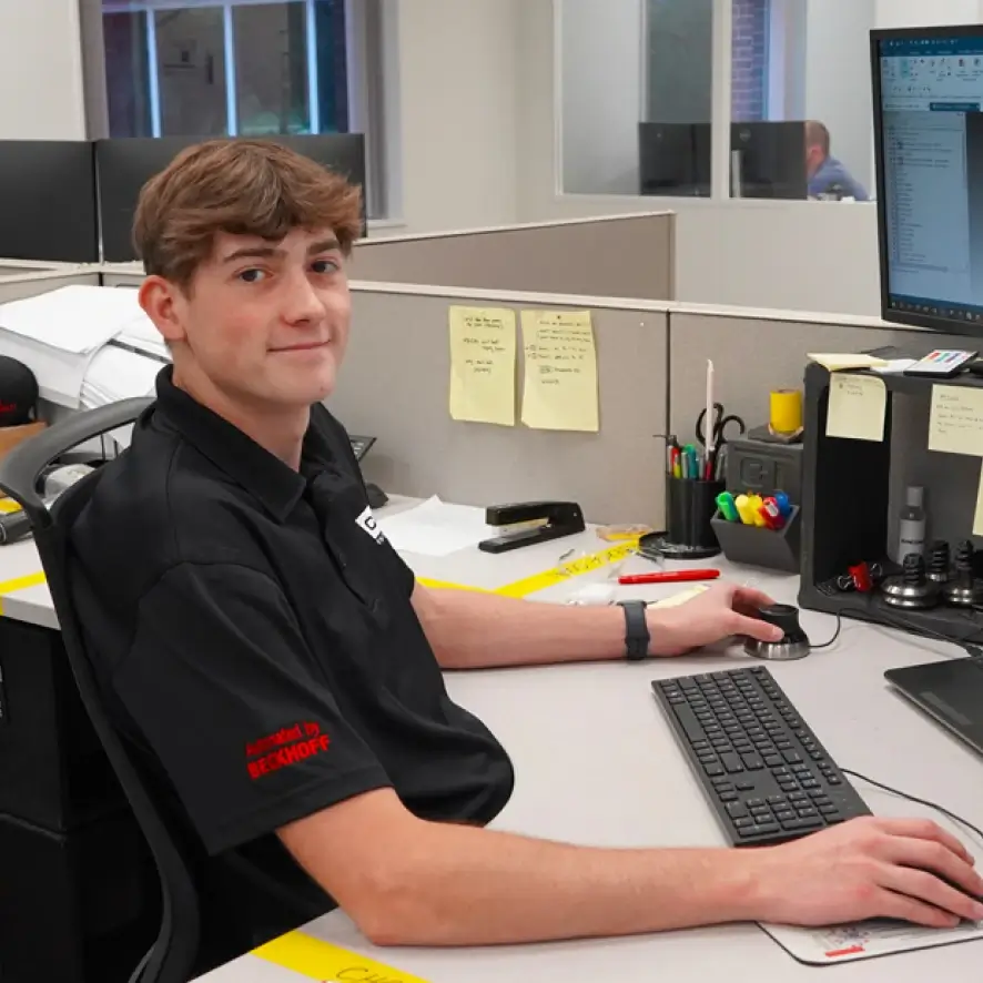 Cincinnati Incorporated interns working on a technical project together.