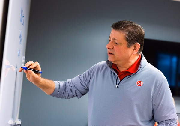 A Dierbergs financial team member speaking with two other associates