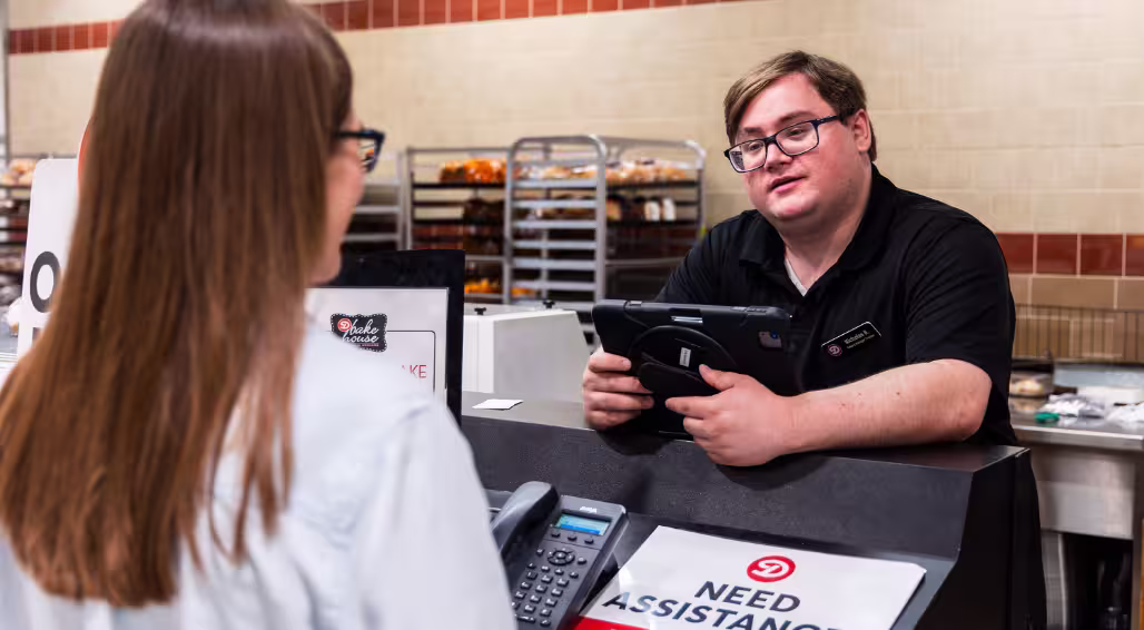 A Dierbergs store manager talking with a fellow team member.