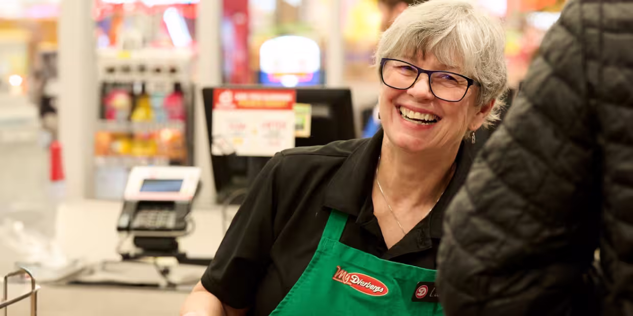A Dierbergs cashier smiling and helping a customer