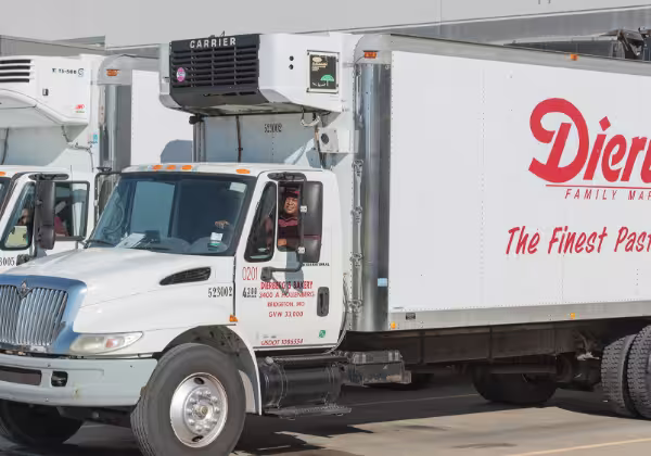 A driver in a white Dierbergs semi-truck with the red company logo on the side