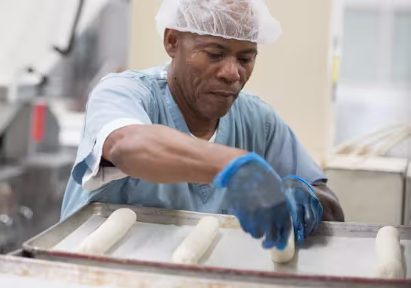 A Dierbergs associate wearing a hair net while working