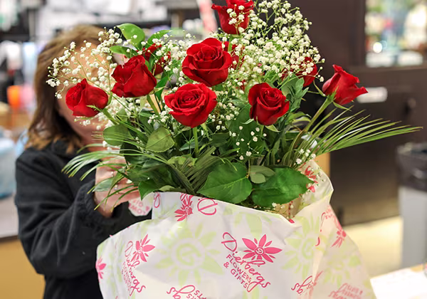 A bouquet of red roses with baby's breath accent flowers