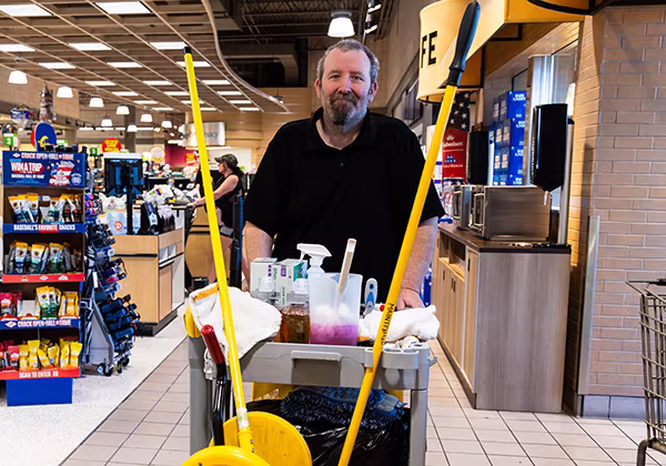 A Dierbergs maintenance team member walking and smiling