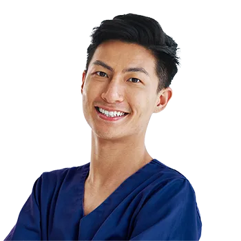A smiling radiology professional in dark blue scrubs.