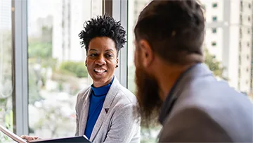 Two corporate professionals talking.