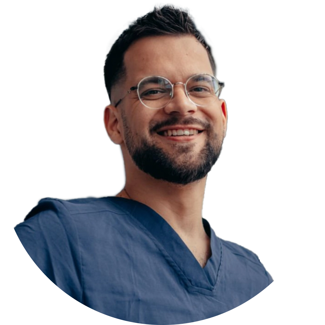 A smiling radiology professional in dark blue scrubs.