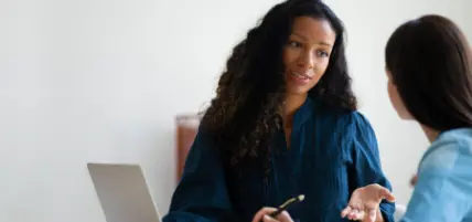 Two diverse women having a conversation.