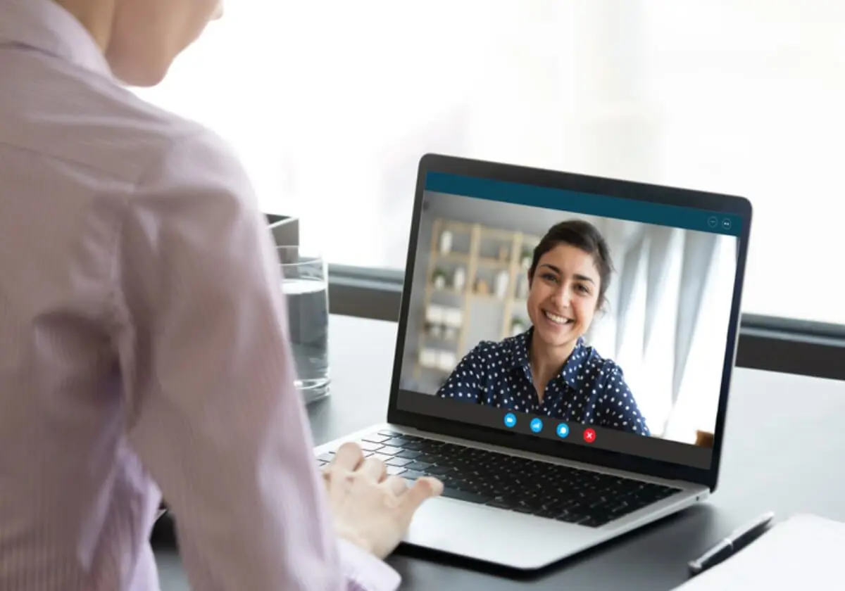 A counselor conducting a telehealth session on her laptop.