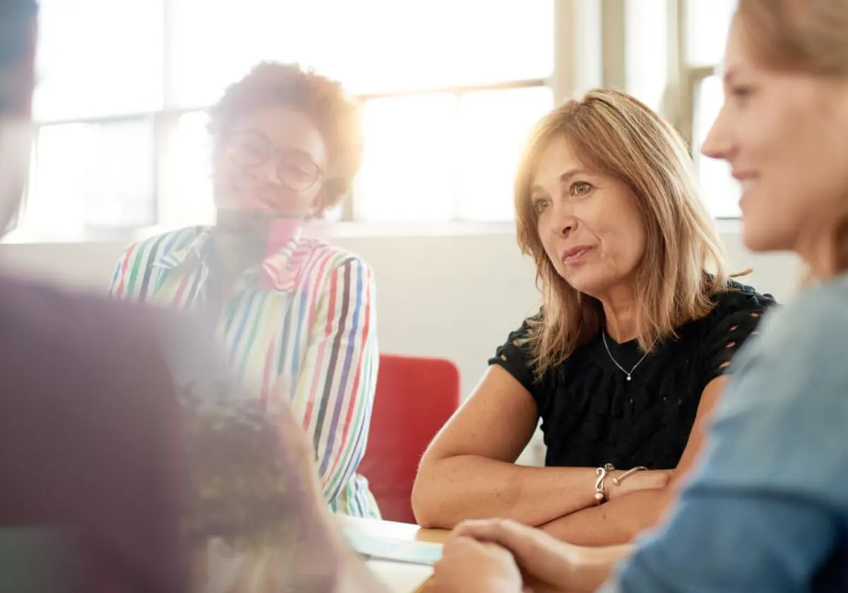 Four colleagues sitting around a table discussing treatment options.