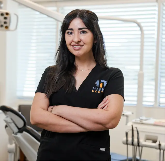 A Gen4 Dental Partners dental hygienist standing and smiling.