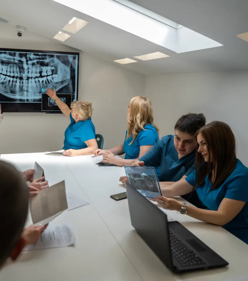 A team of dental professionals collaborating while viewing x-rays.