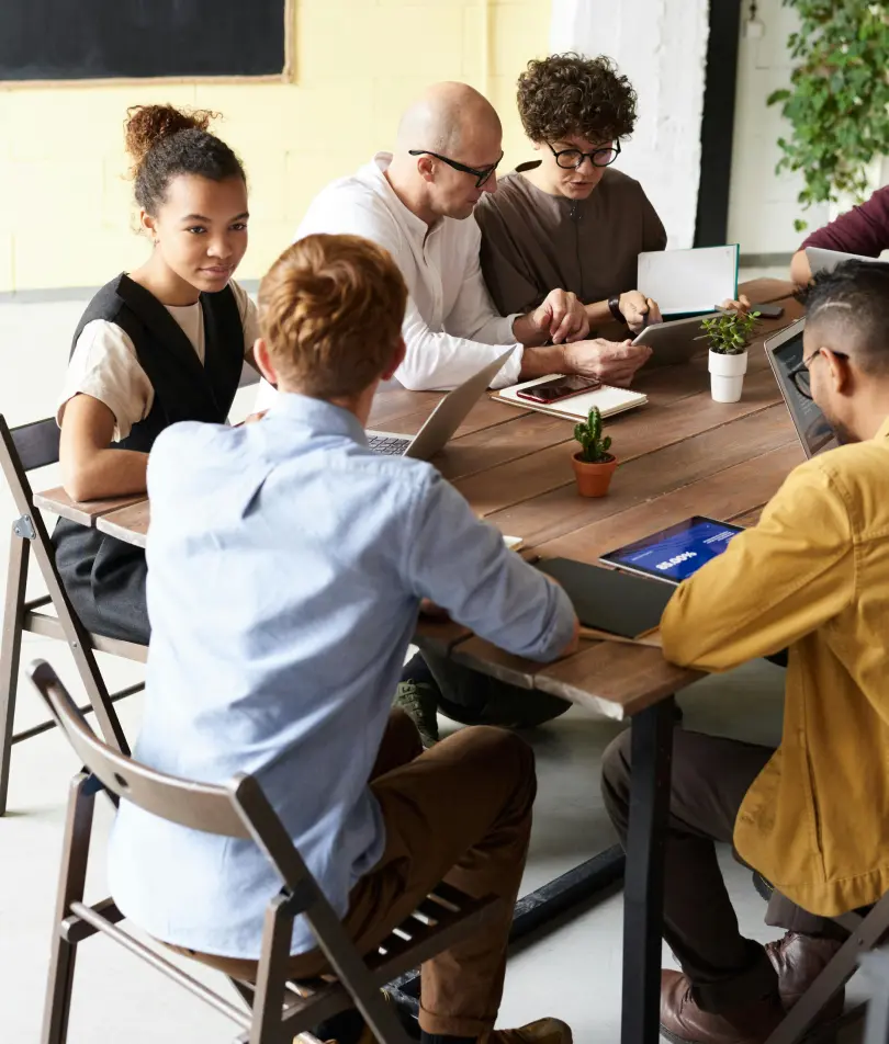 A table of IT professionals reviewing dental software.