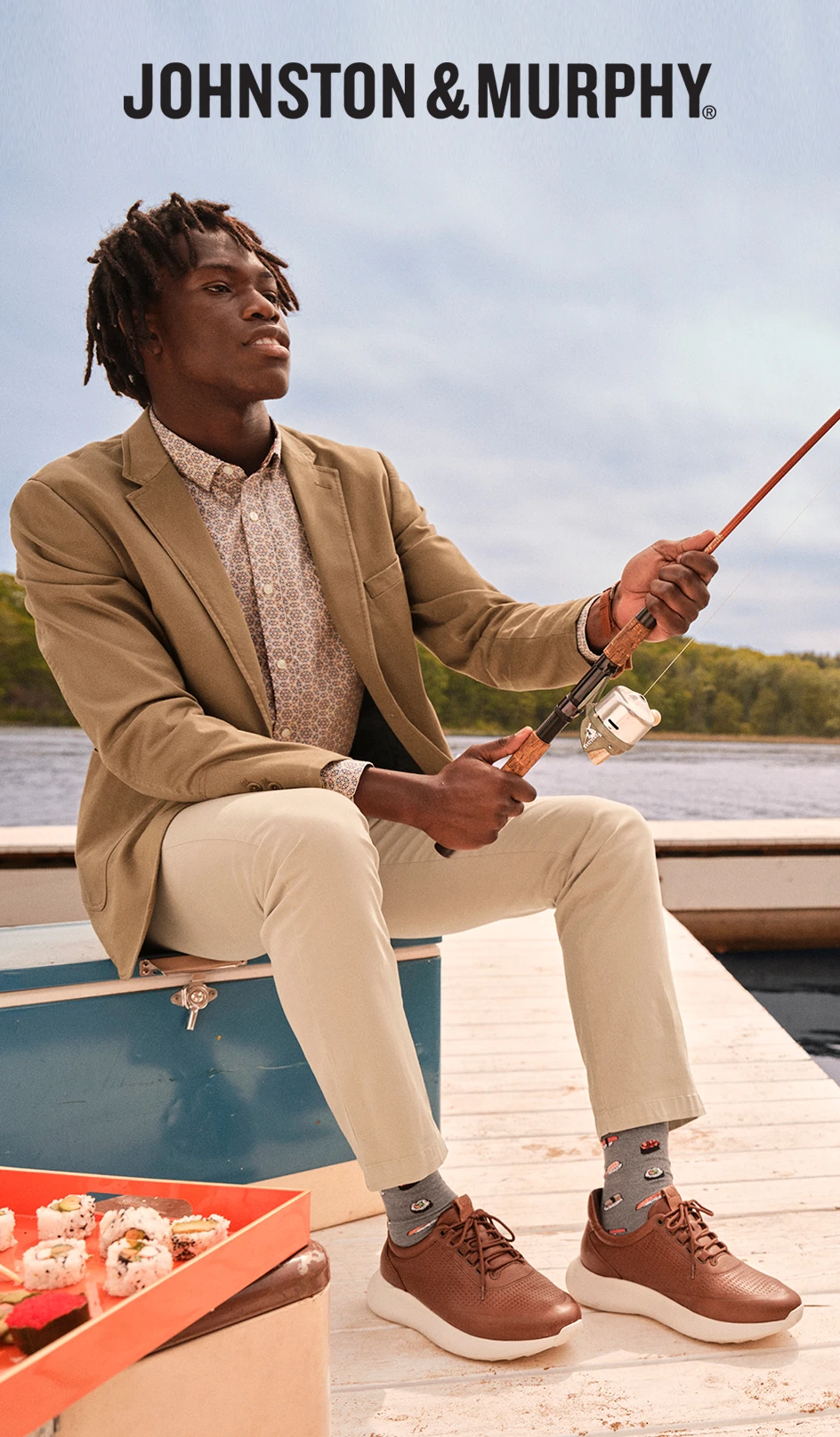 Model fishing on a dock wearing Johnston & Murphy casual shoes.