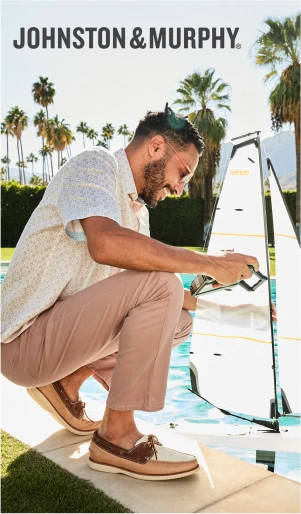 Model fishing on a dock wearing Johnston & Murphy casual shoes.