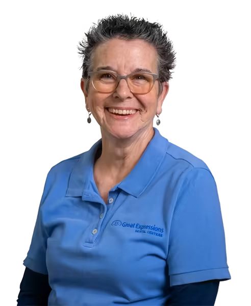Smiling office support team member in glasses and a blue polo shirt.