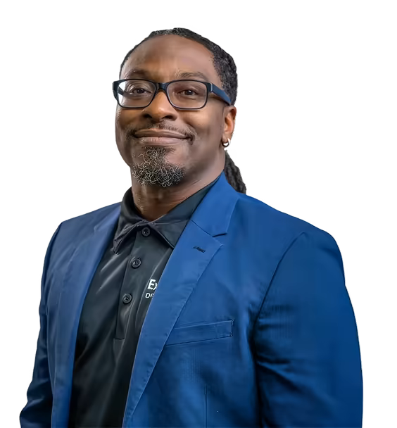 Smiling corporate team member wearing a polo shirt and blazer.