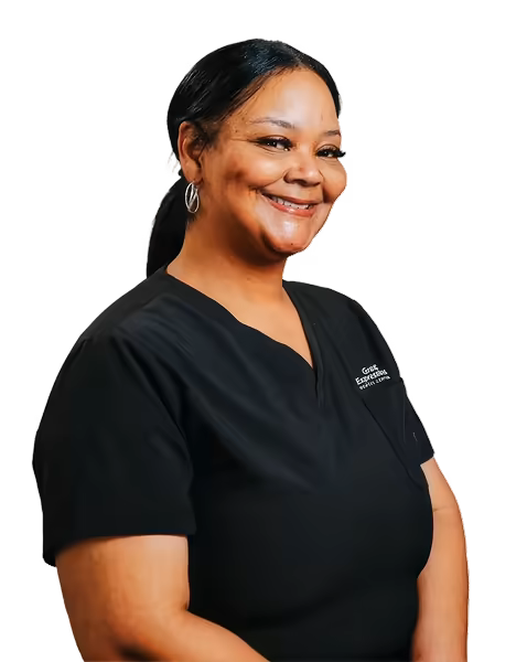Happy dental professional wearing black scrubs.