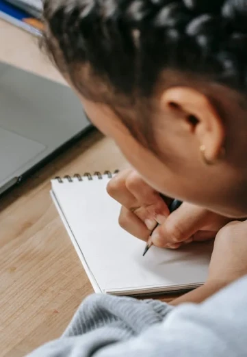 Young student writing on the paper
