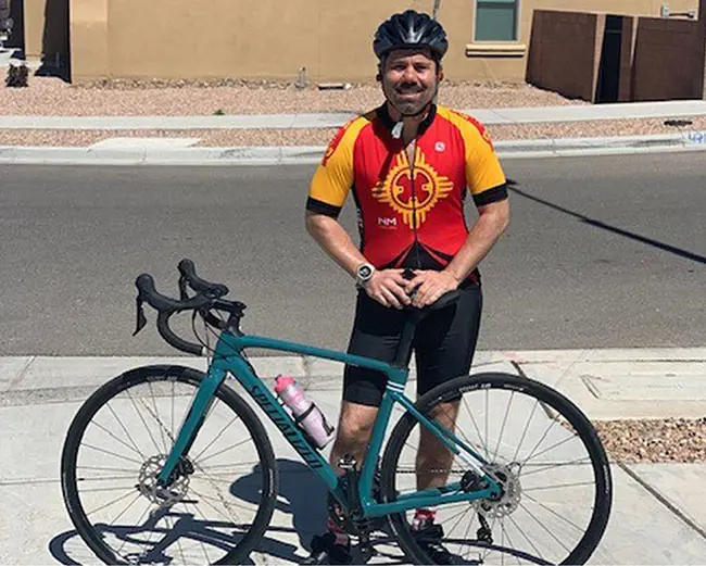LANL employee, Joe, smiling with a bike.