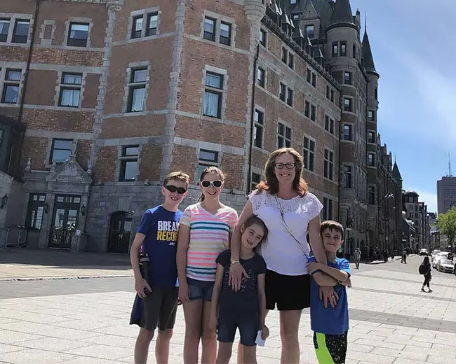Stacy, a LANL division leader, stands with her four children at a vacation site.