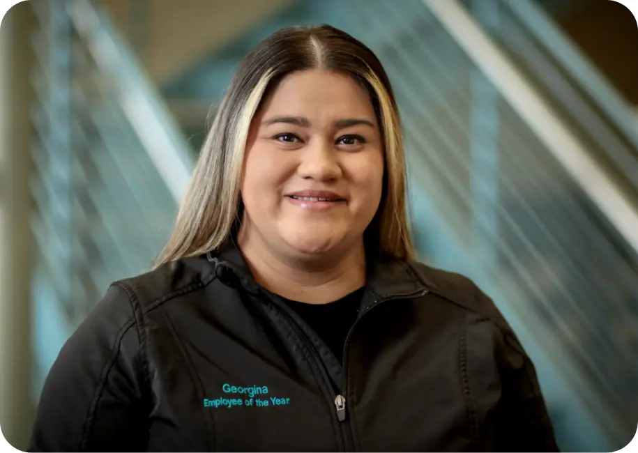 A Brown University Health employee wearing a “Employee of the Year” jacket.