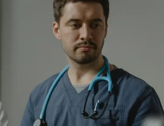 A healthcare professional wearing scrubs and a stethoscope.