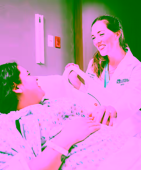 Respiratory therapist doctor smiling and talking with patient in hospital room